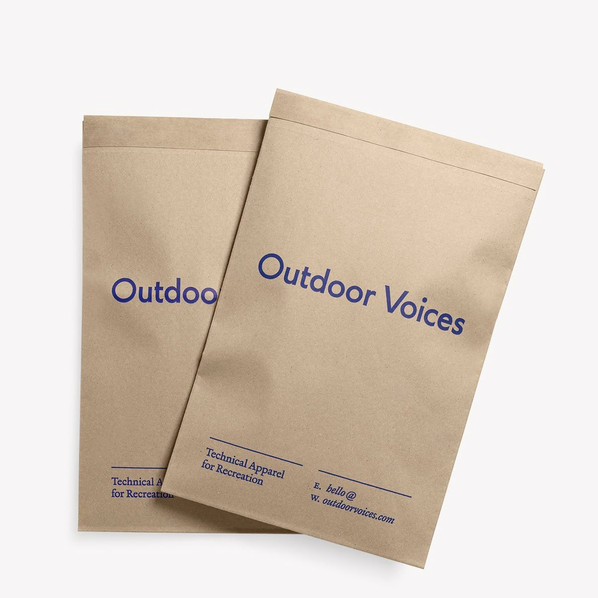 Outdoor Voices unbleached kraft paper mailer with single bold cobalt blue logotype