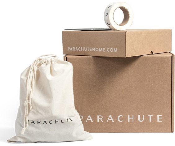 Parachute unadorned kraft corrugated shipper with product wrapped in a reusable canvas drawstring bag