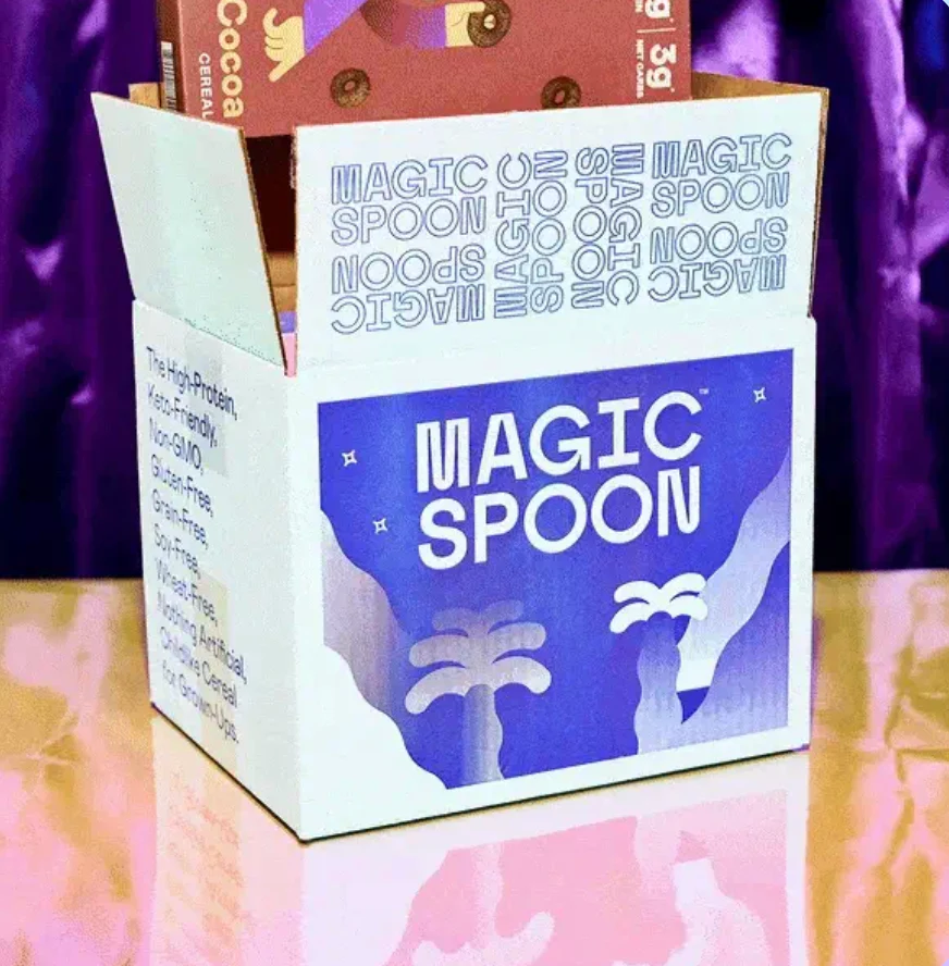 Magic Spoon corrugated shipper with bold illustrated full-coverage exterior print and mirrored logo interior lid